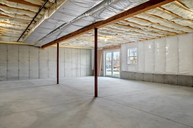 a view of empty room with wooden walls
