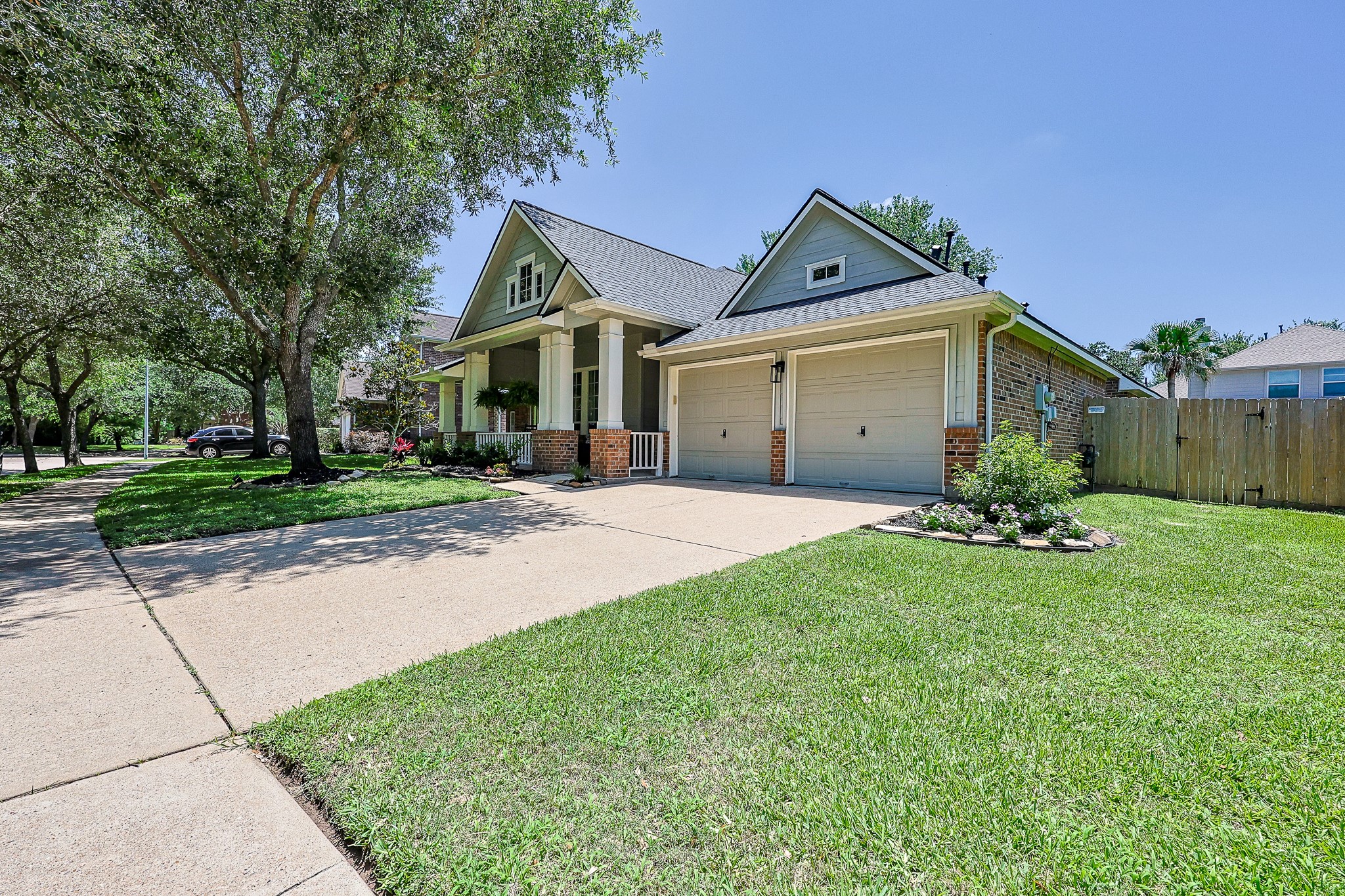 10306 Rudolph Court Missouri City, TX 77459 - Photo 3 of 34 Generous double wide driveway leads to a garage with dual garage doors, EV charger and extra storage for gear.