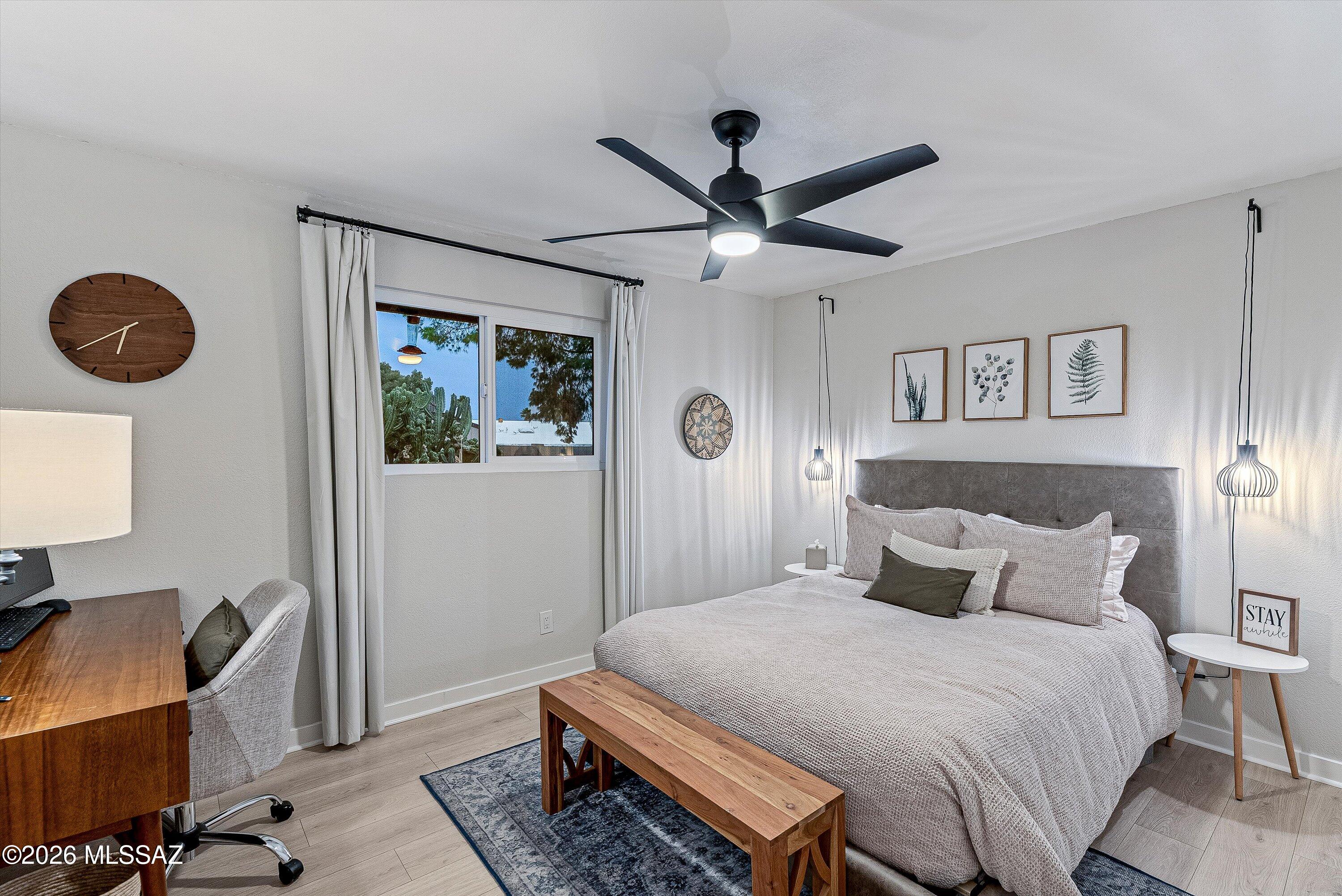 3949 West Mars Street Tucson, AZ 85741 - Photo 17 of 27 a bedroom with a bed and a chandelier