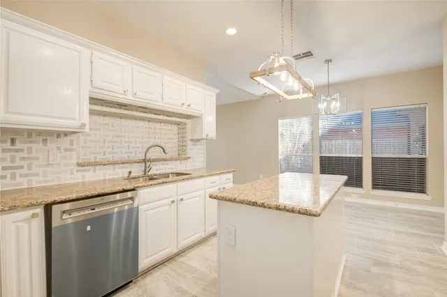 a kitchen with a sink cabinets and window