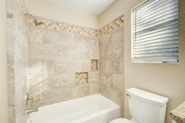 a bathroom with a bathtub and a toilet