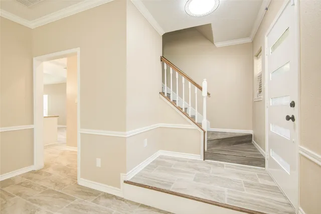 a view of entryway and hall with wooden floor