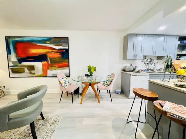a kitchen filled with white cabinets and appliances
