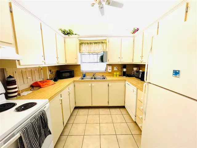 a living room with kitchen pool table and chairs