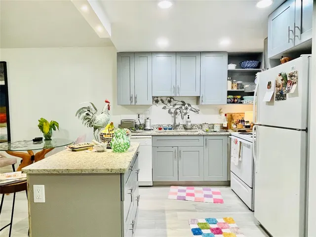 a kitchen with a sink stove and refrigerator
