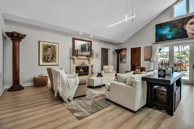 a living room with furniture a flat screen tv and a fireplace