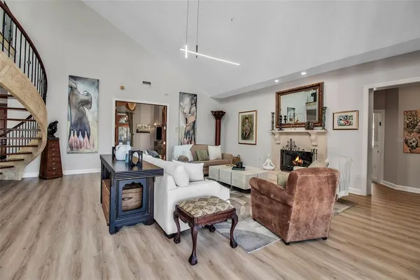 a living room with furniture a fireplace and a table
