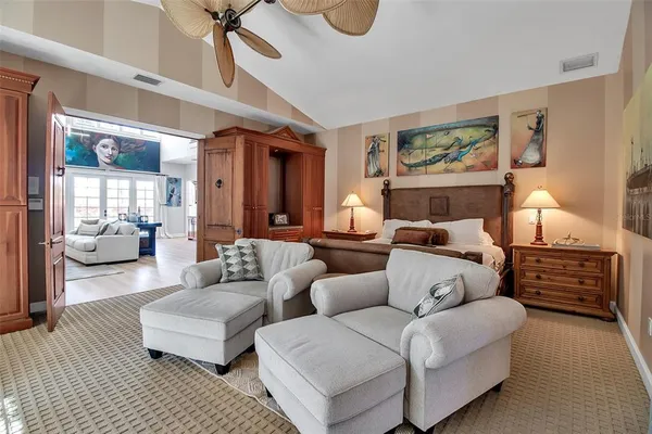 a living room with furniture and a ceiling fan