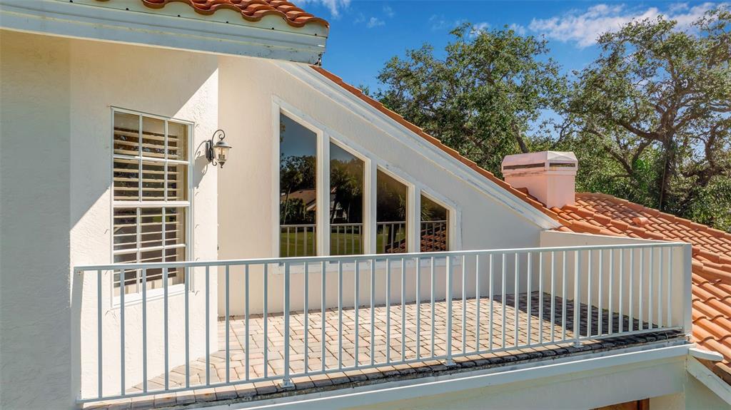 401 Walls Way Osprey, FL 34229 - Photo 26 of 51 a view of a balcony with a floor to ceiling window and tree
