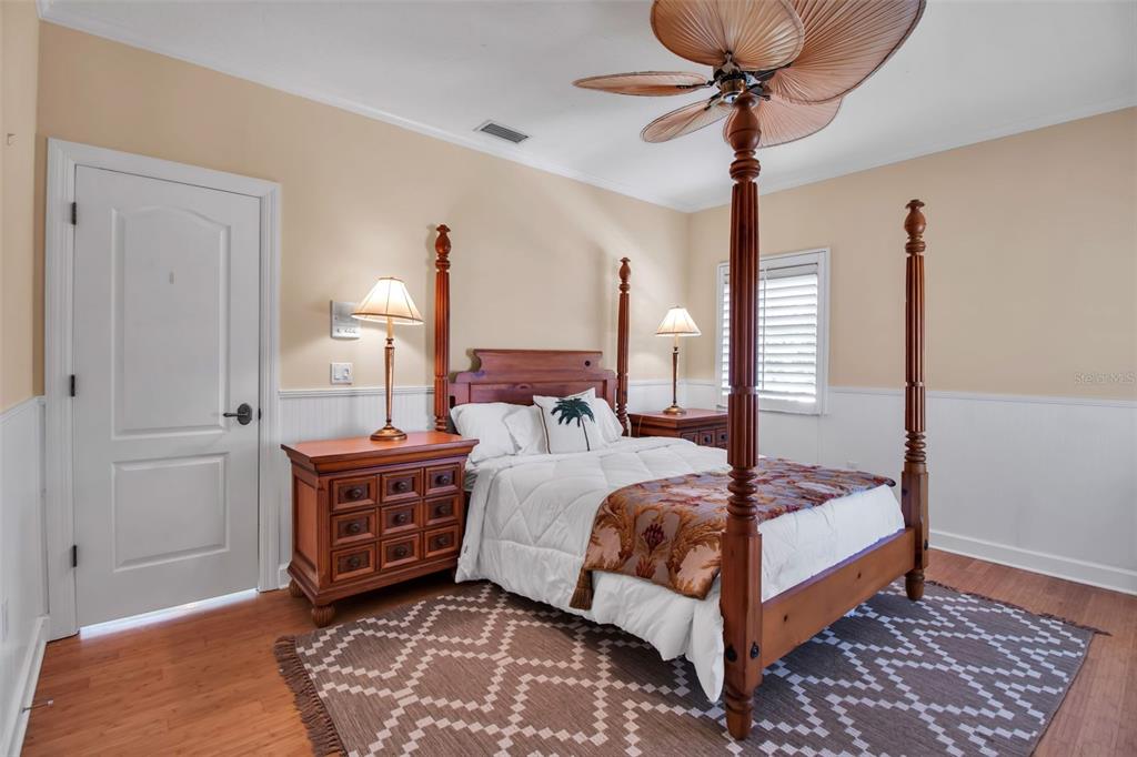 401 Walls Way Osprey, FL 34229 - Photo 28 of 51 a bedroom with a bed and a chandelier