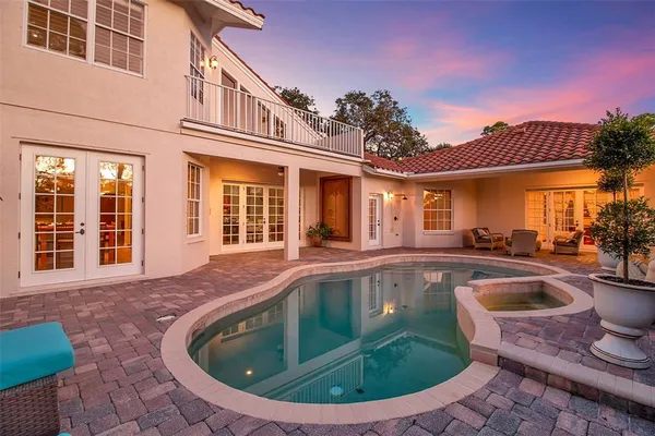 a view of a house with swimming pool and porch