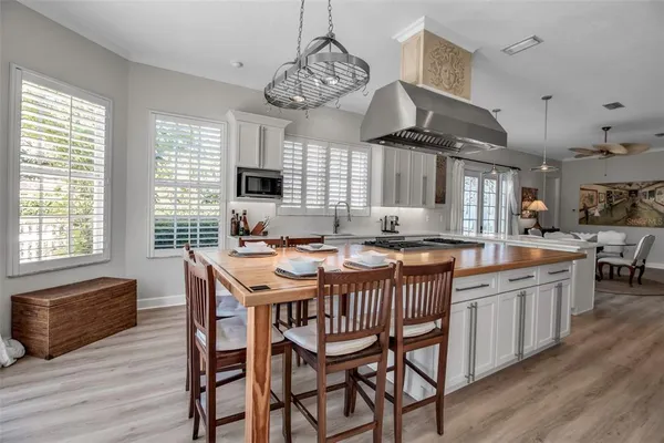 a dining table with chairs and wooden floor