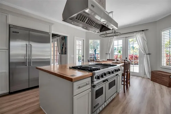 a kitchen with stainless steel appliances granite countertop a stove and a refrigerator