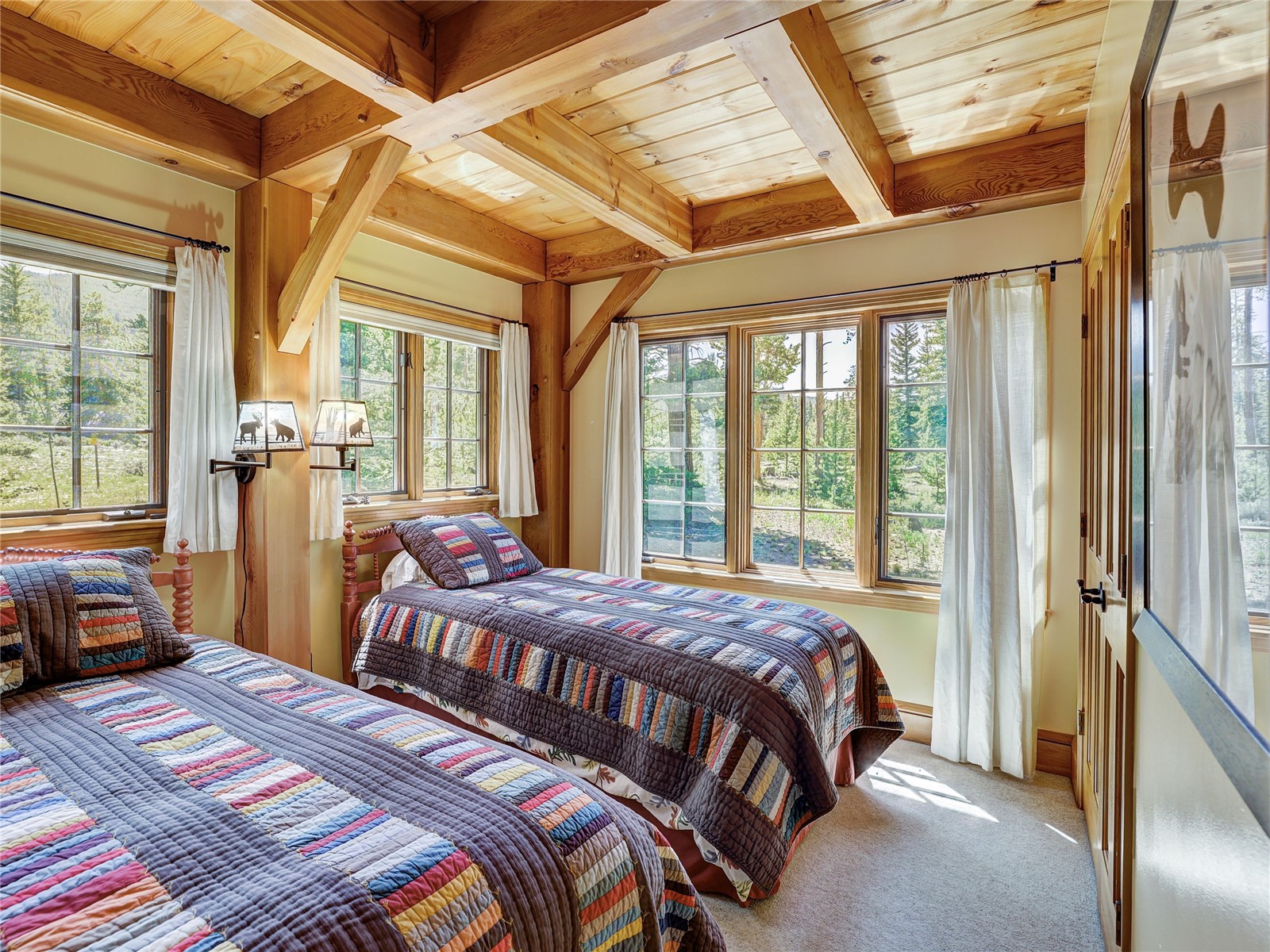 840 Penstemon Road Keystone, CO 80435 - Photo 24 of 50 Carpeted bedroom featuring a wood ceiling with exposed beams and multiple windows