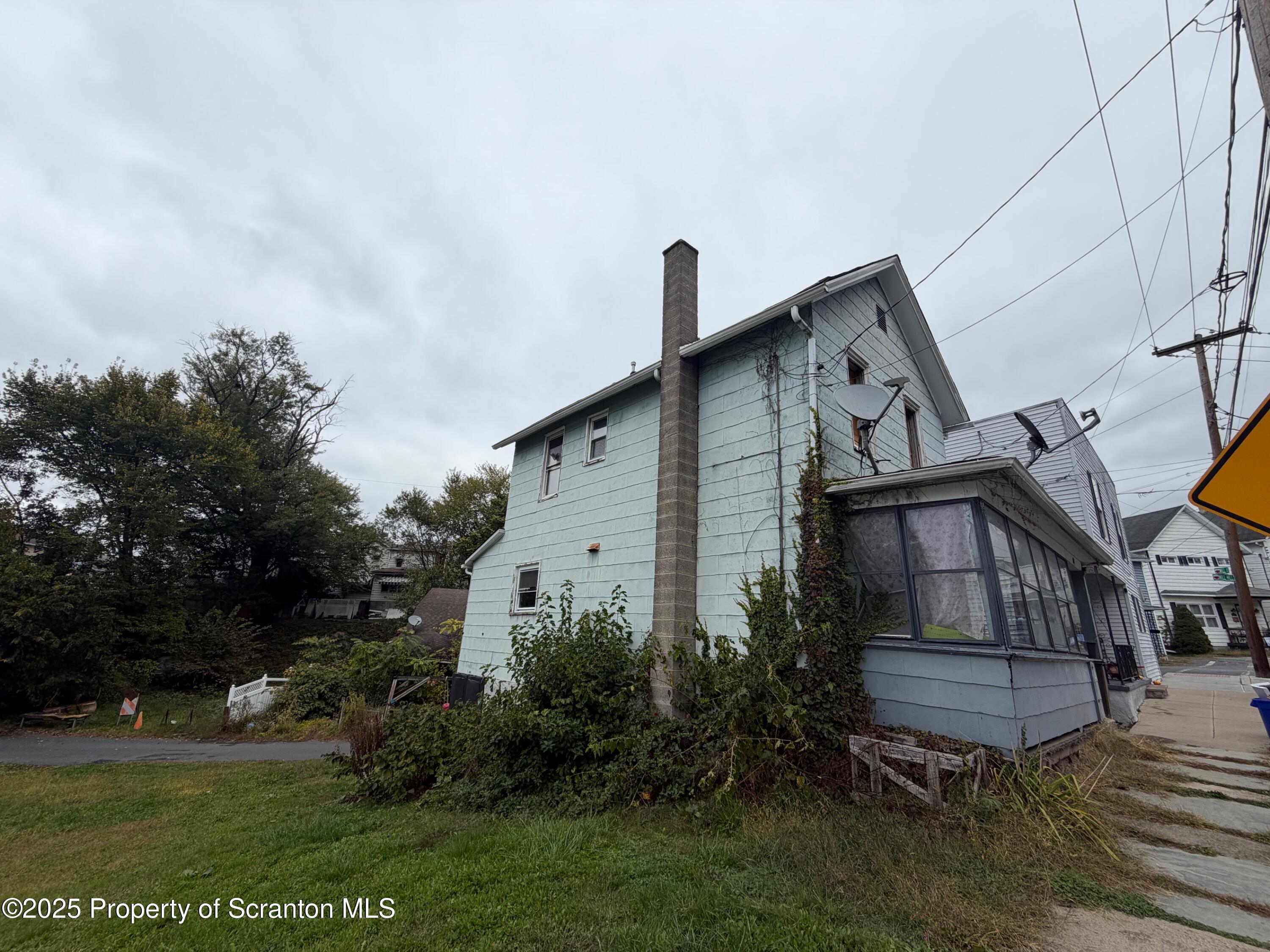 60 Mill Street Pittston, PA 18640 - Photo 2 of 33 a front view of a house with garden