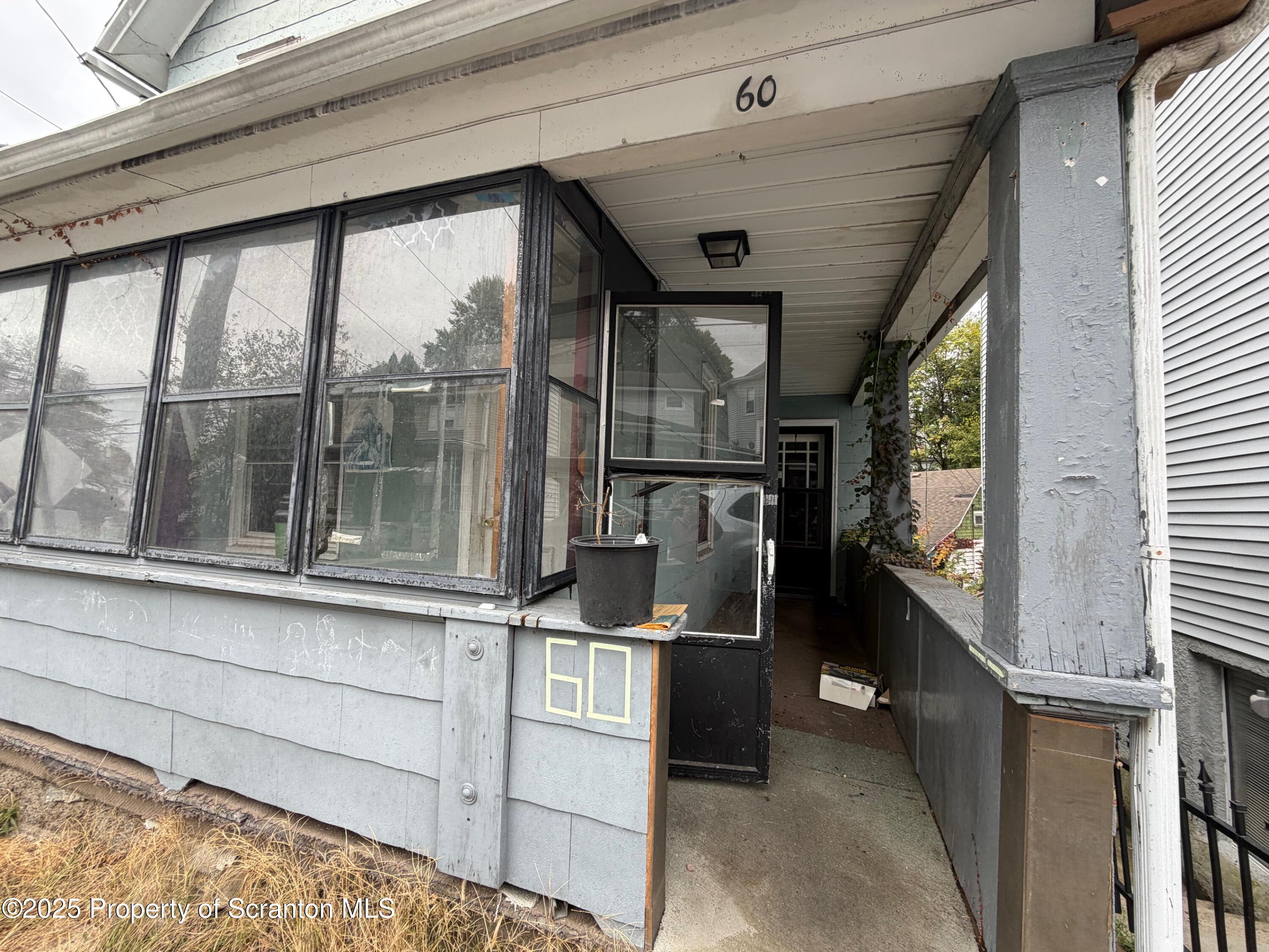 60 Mill Street Pittston, PA 18640 - Photo 4 of 33 a kitchen with windows and refrigerator