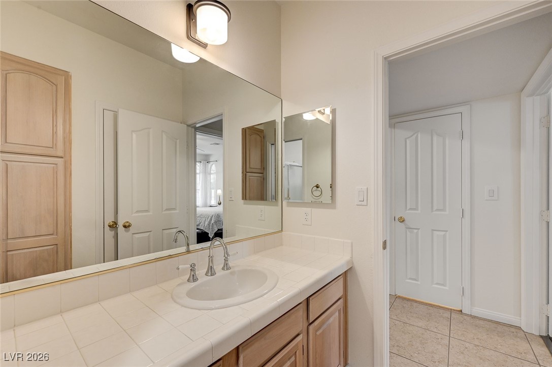 2955 El Camino Road Las Vegas, NV 89146 - Photo 49 of 99 Ensuite bathroom featuring vanity and light tile patterned floors
