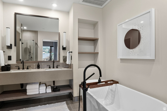 2417 West High Road, Unit 3210 Park City, UT 84098 - Photo 23 of 44 Primary bath with a double vanity, freestanding soaking tub and matte black fixtures, the case for a slow morning.