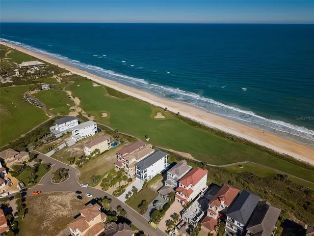 an aerial view of a house with a ocean view