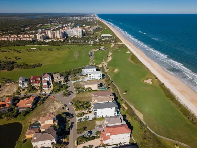 an aerial view of residential houses with outdoor space and swimming pool