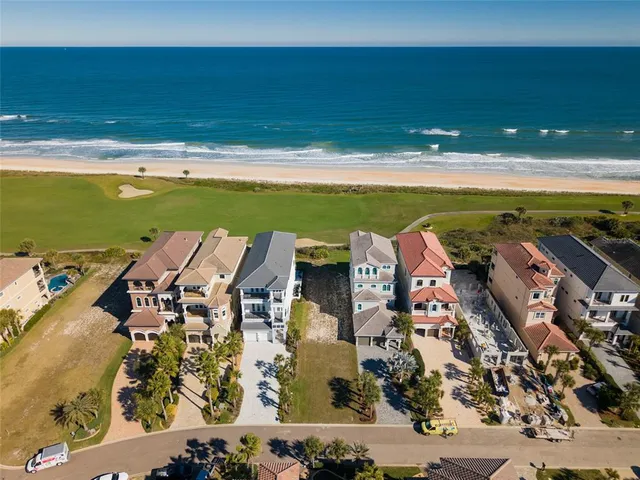 an aerial view of a house with yard swimming pool and outdoor seating