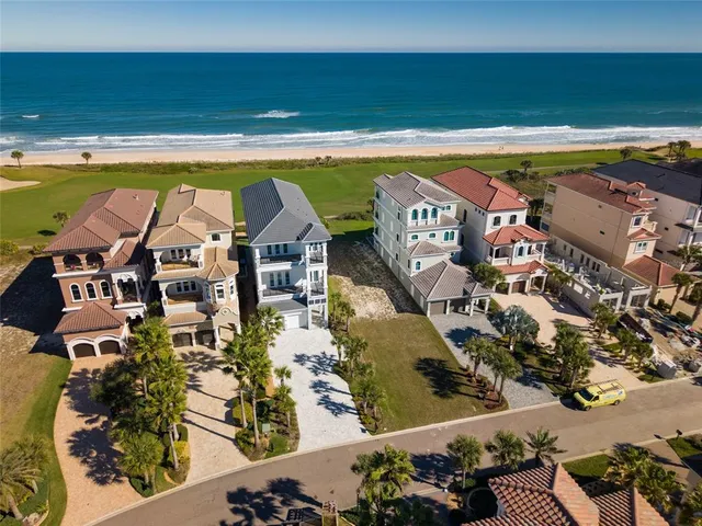 an aerial view of a house with swimming pool and porch