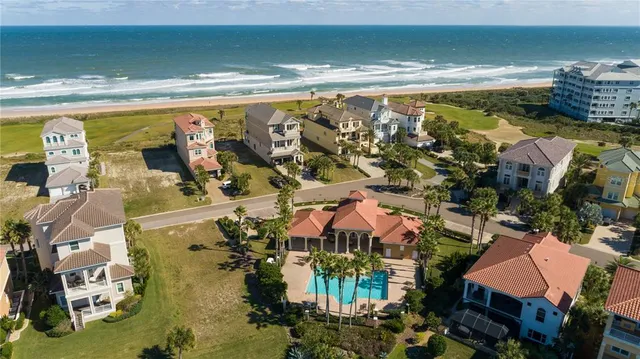 a view of a patio with a table chairs and a swimming pool