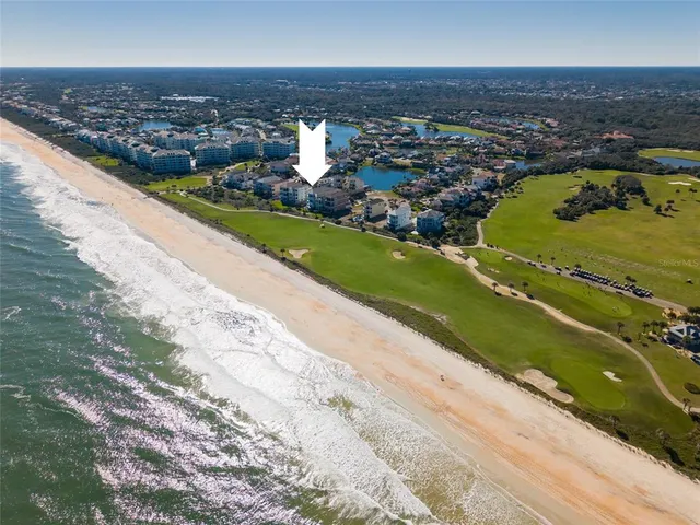 an aerial view of a house with a swimming pool