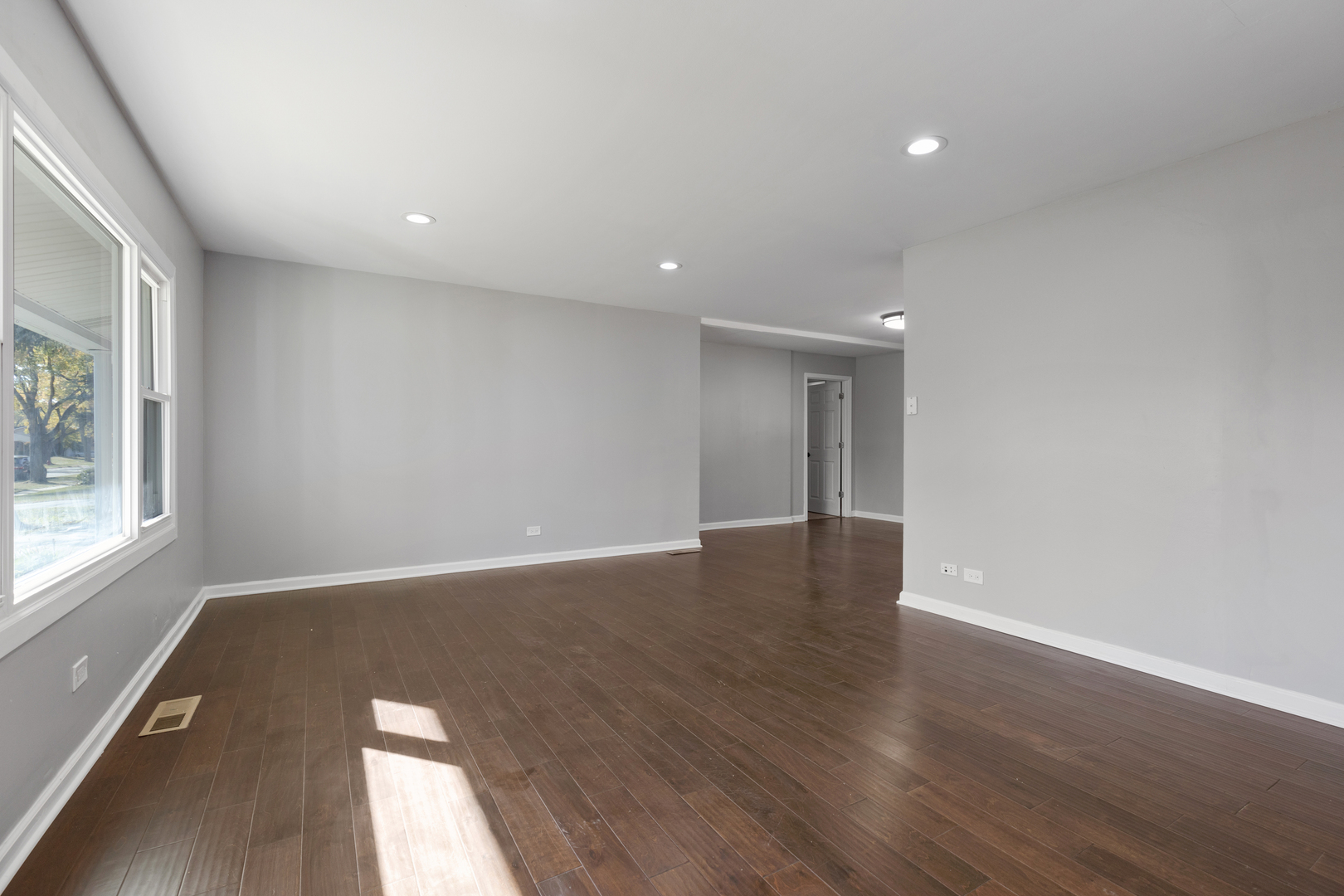 960 Olive Street Hoffman Estates, IL 60169 - Photo 3 of 22 an empty room with wooden floor and windows