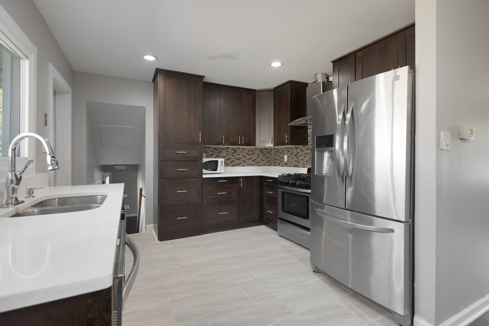 960 Olive Street Hoffman Estates, IL 60169 - Photo 5 of 22 a kitchen with kitchen island a refrigerator stove and sink