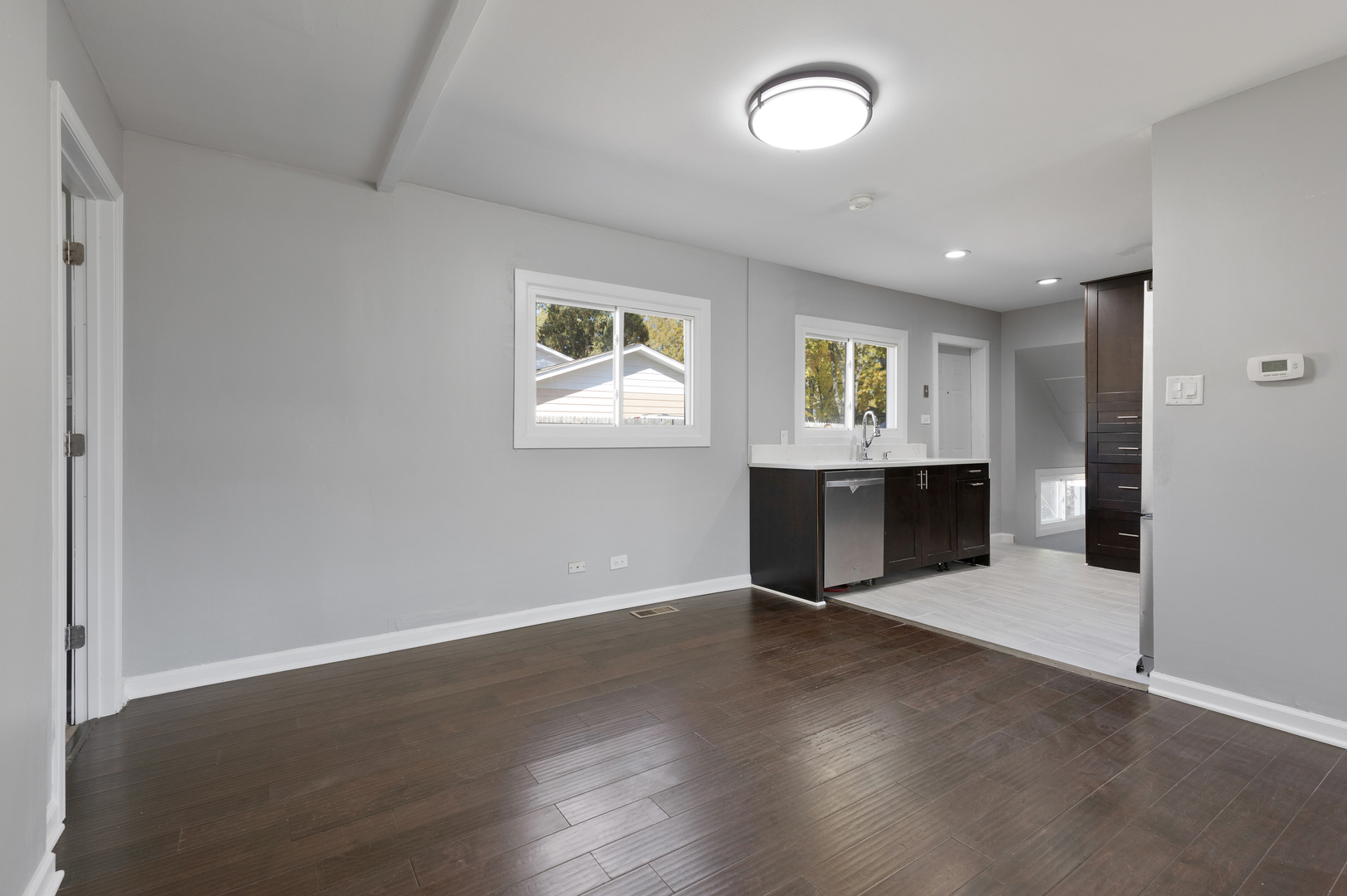 960 Olive Street Hoffman Estates, IL 60169 - Photo 6 of 22 an empty room with wooden floor and windows