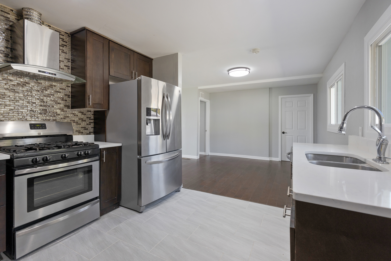 960 Olive Street Hoffman Estates, IL 60169 - Photo 8 of 22 a kitchen with a stove refrigerator and a sink