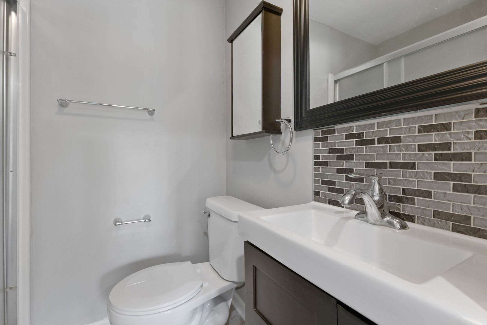 960 Olive Street Hoffman Estates, IL 60169 - Photo 10 of 22 a bathroom with a sink a toilet and mirror