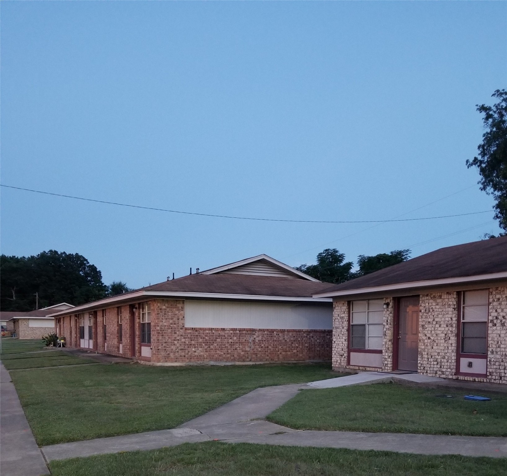 1300 Courtland Road Atlanta, TX 75551 - Photo 3 of 7 a front view of a house with a yard and garage