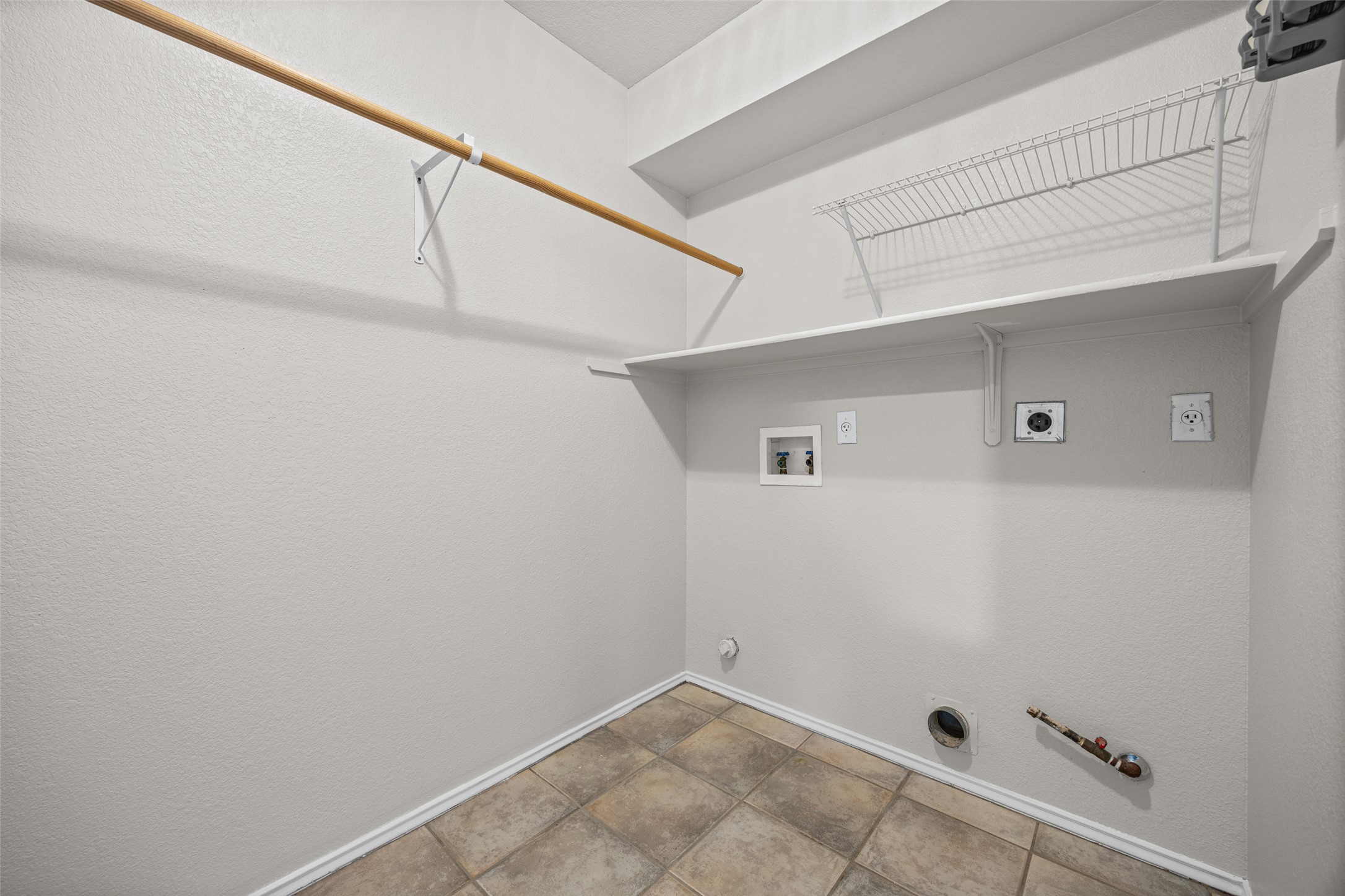 1524 Lochaline Loop Pflugerville, TX 78660 - Photo 11 of 22 A dedicated laundry room with practical shelving and a clothes rod for everyday convenience.