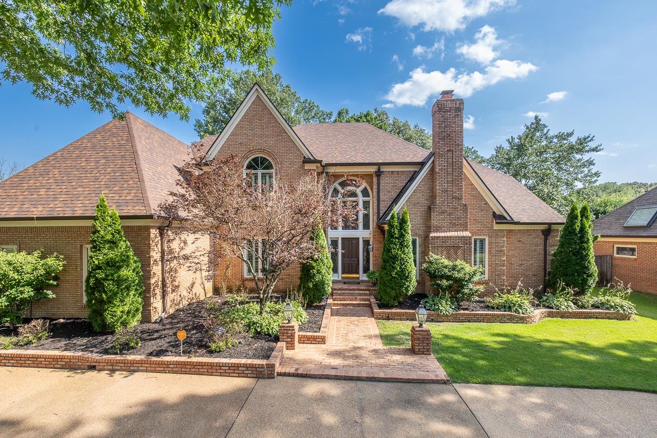 9637 Spring Meade Lane Germantown, TN 38139 - Photo 1 of 25 a front view of a house with garden