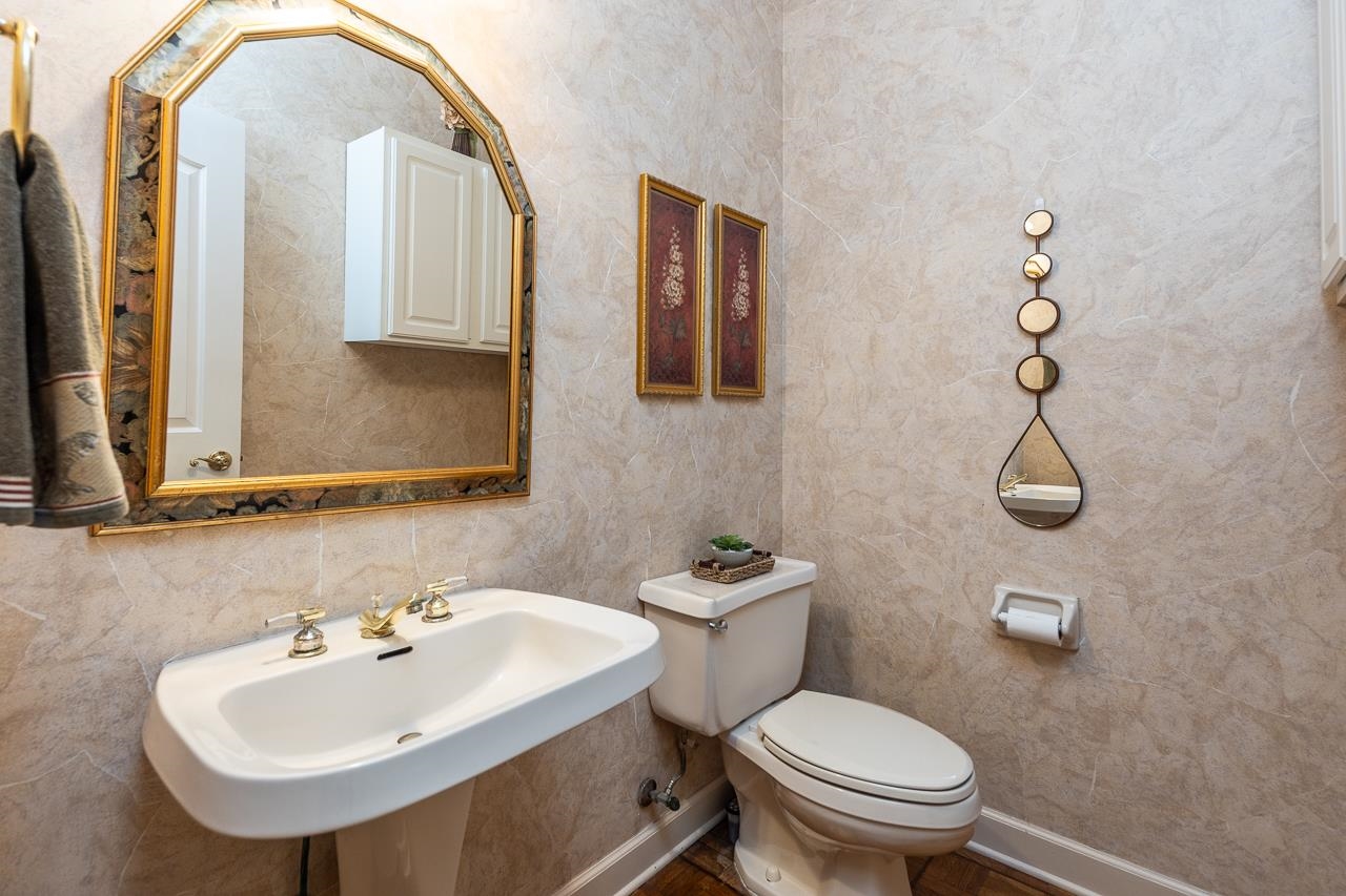9637 Spring Meade Lane Germantown, TN 38139 - Photo 12 of 25 a bathroom with a toilet sink and mirror