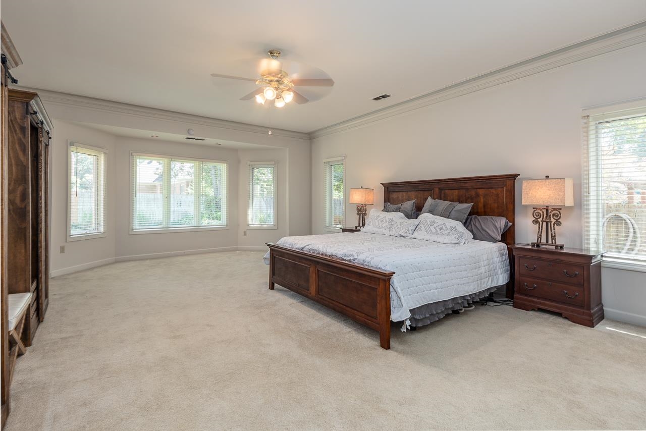 9637 Spring Meade Lane Germantown, TN 38139 - Photo 13 of 25 a spacious bedroom with a bed and a chandelier