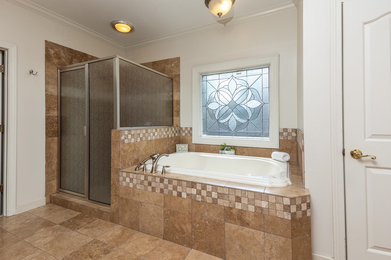 9637 Spring Meade Lane Germantown, TN 38139 - Photo 15 of 25 a bathroom with a bathtub and a shower
