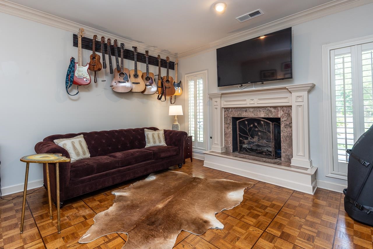 9637 Spring Meade Lane Germantown, TN 38139 - Photo 20 of 25 a living room with furniture a flat screen tv and a fireplace