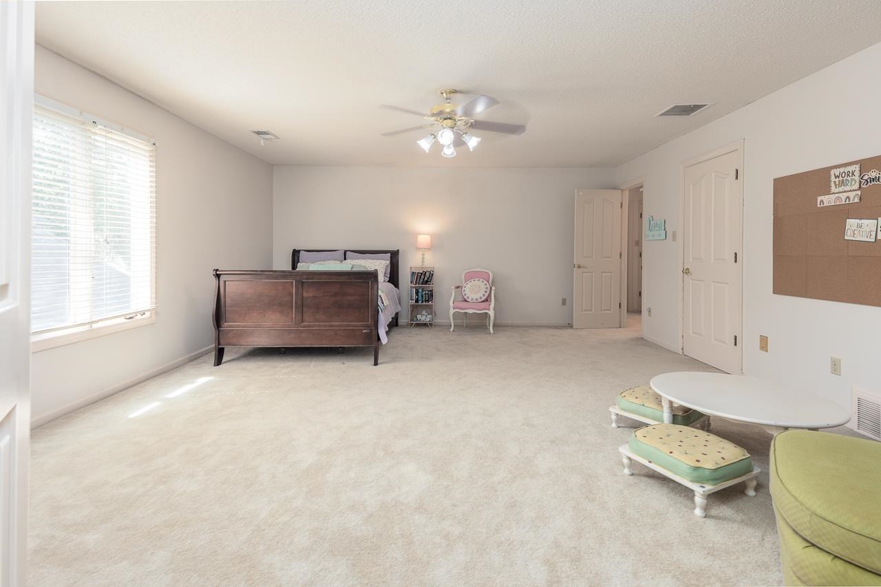 9637 Spring Meade Lane Germantown, TN 38139 - Photo 22 of 25 a living room with furniture and a chandelier