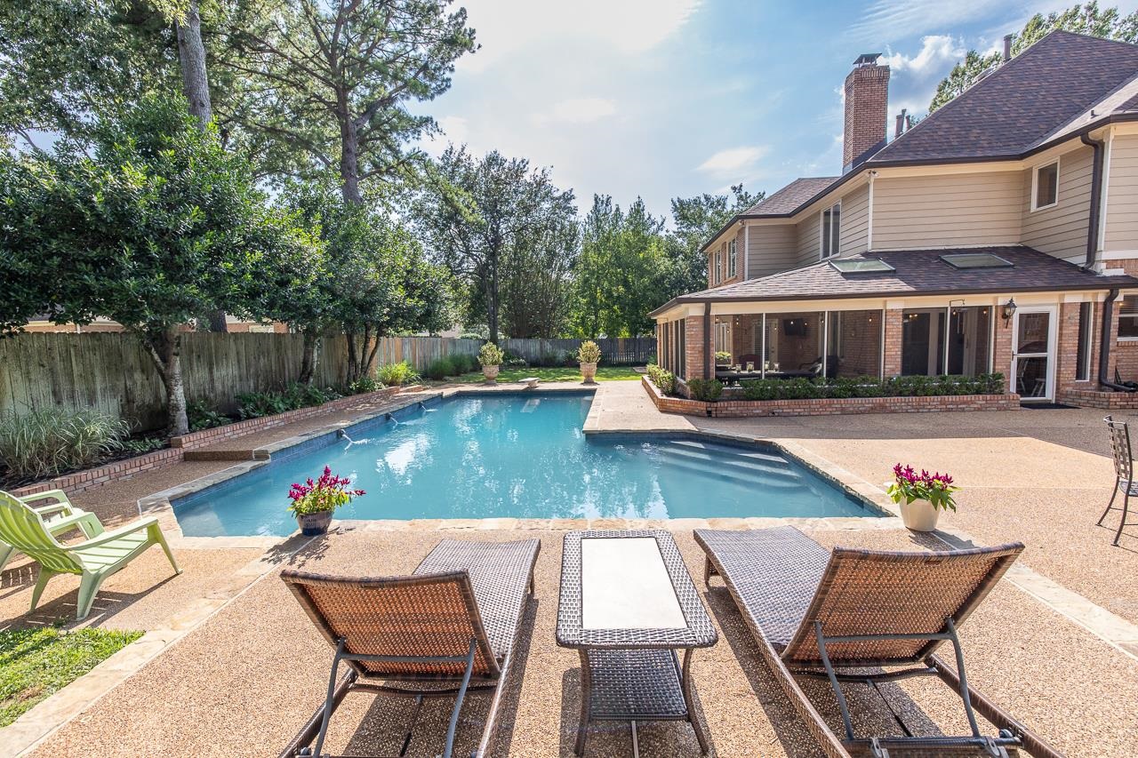 9637 Spring Meade Lane Germantown, TN 38139 - Photo 3 of 25 a view of swimming pool with seating area and trees in the background