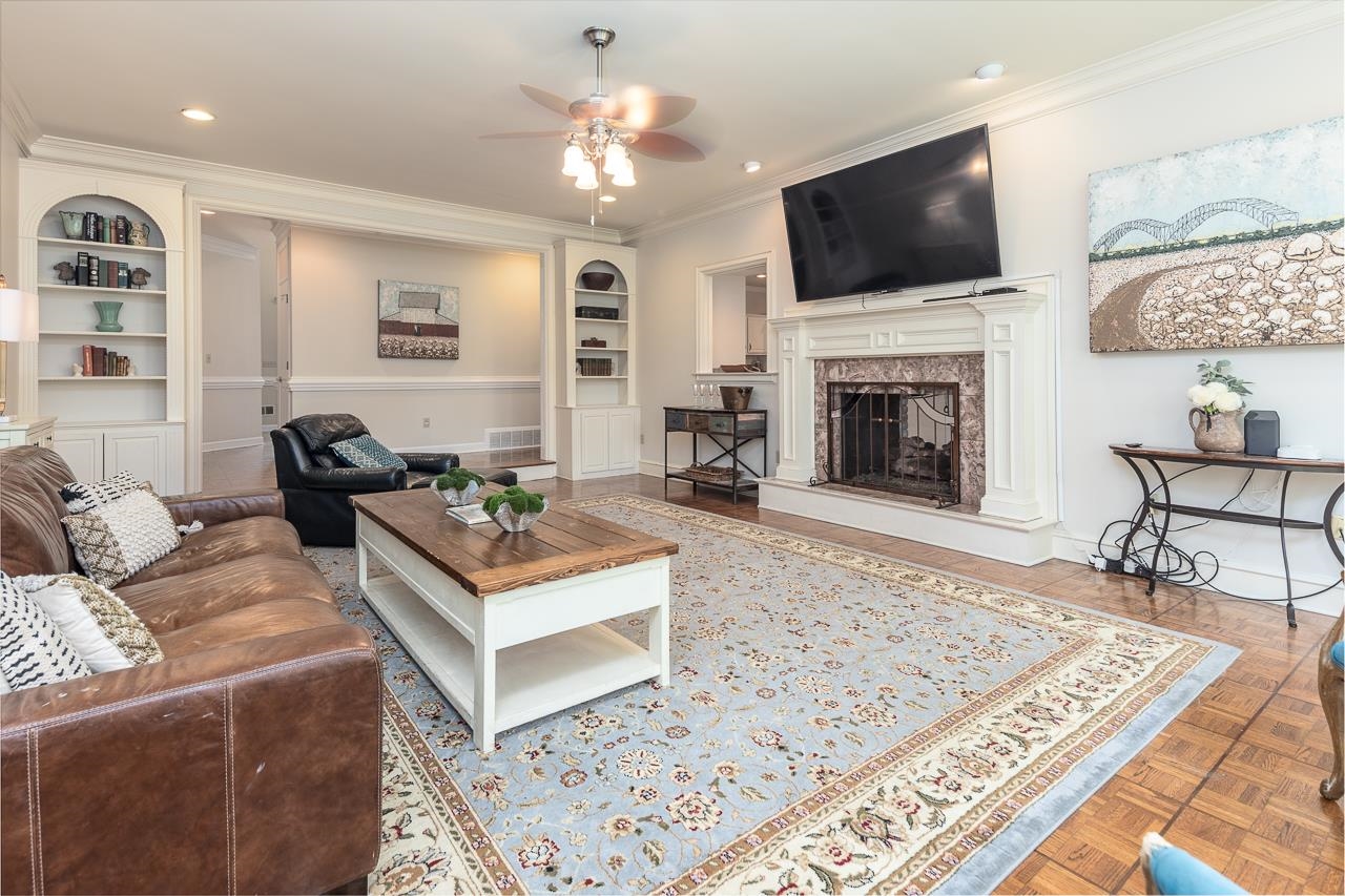 9637 Spring Meade Lane Germantown, TN 38139 - Photo 9 of 25 a living room with furniture a flat screen tv and a fireplace