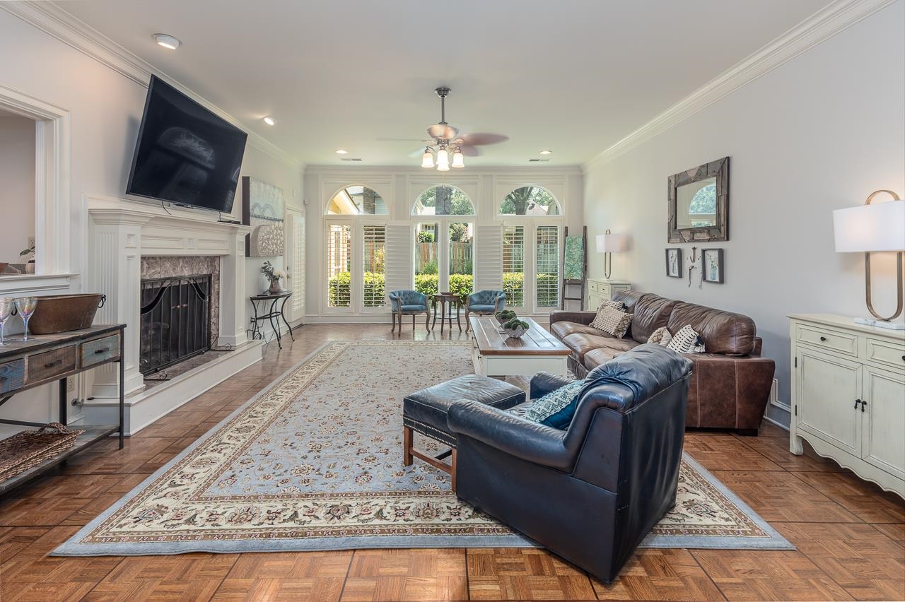 9637 Spring Meade Lane Germantown, TN 38139 - Photo 10 of 25 a living room with furniture a fireplace and a flat screen tv