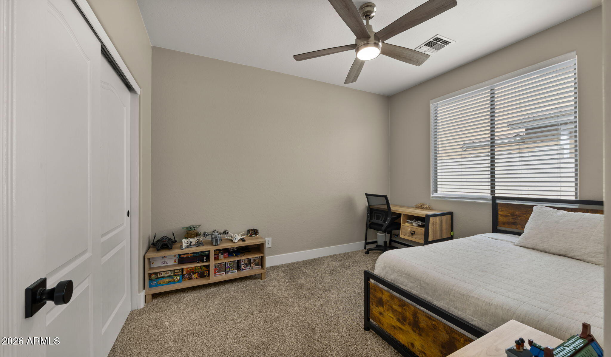 3344 East Hopkins Road Gilbert, AZ 85295 - Photo 18 of 32 a bedroom with a bed and a chandelier