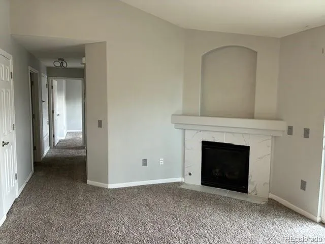 an empty room with a fireplace
