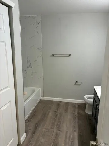 a bathroom with a bathtub and toilet