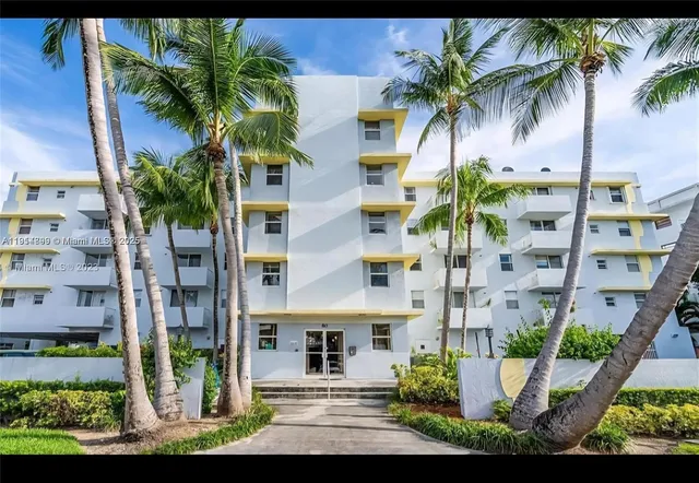 a front view of multiple houses with outdoor space and palm tree