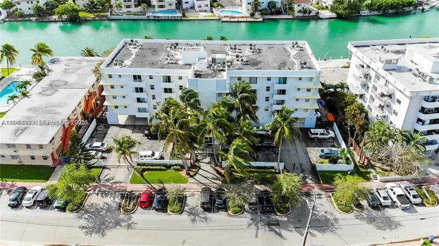 an aerial view of a house with a garden and lake view