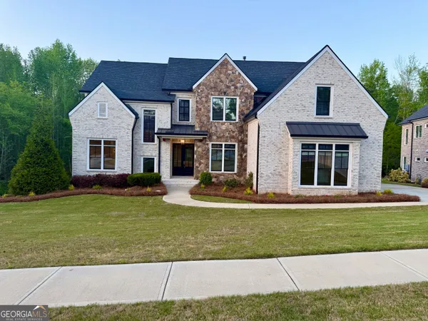 a front view of a house with a yard